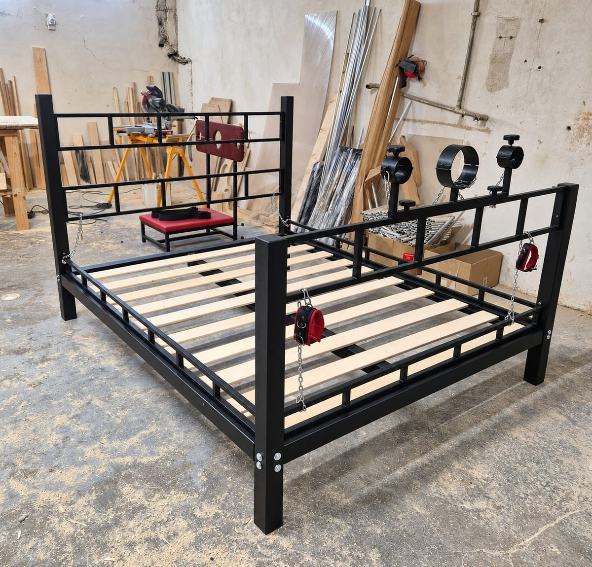 Bondage bed with adjustable removable steel restraint cuffs